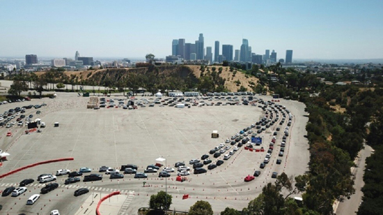 أشخاص بسياراتهم ينتظرون في طابور للخضوع لاختبار كوفيد-19 في لوس أنجليس بالولايات المتحدة